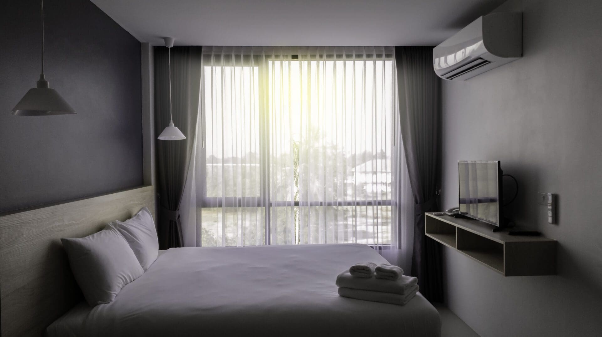 Minimalist hotel room with sheer curtains