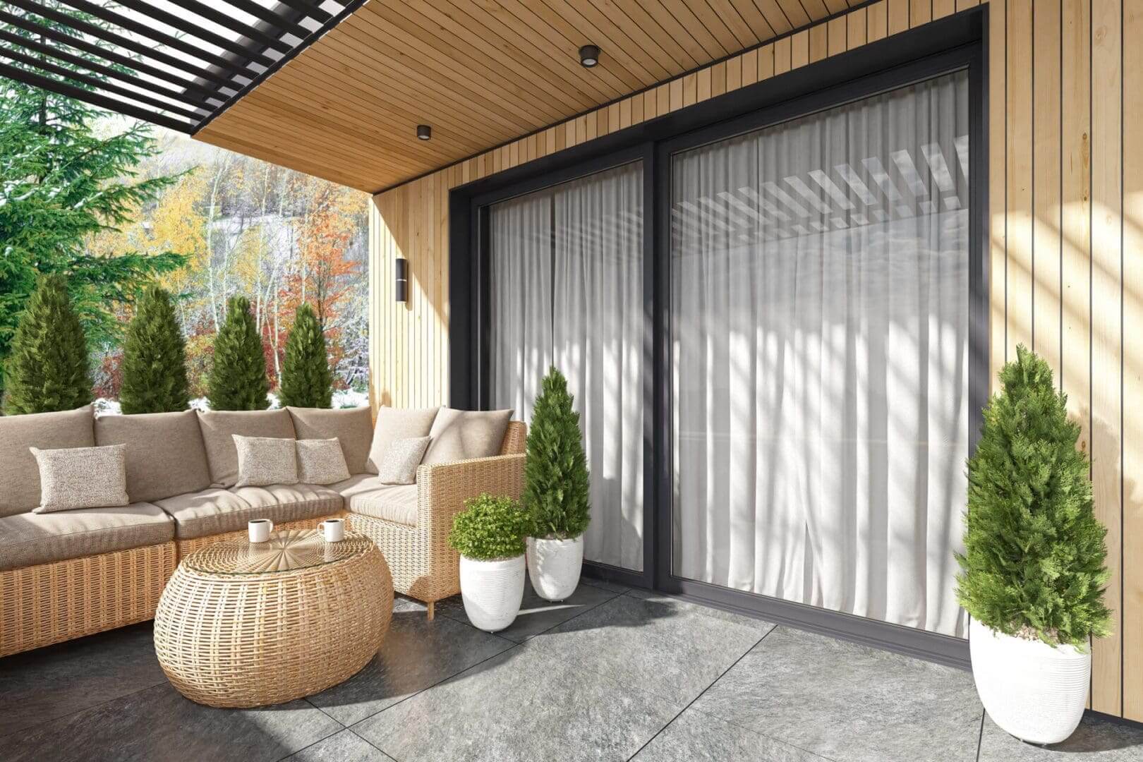 Cozy covered patio with wicker sofa and plants