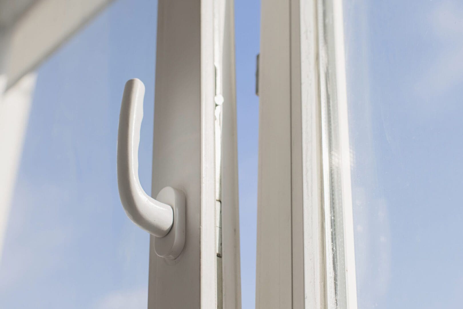 white window handle against clear blue sky