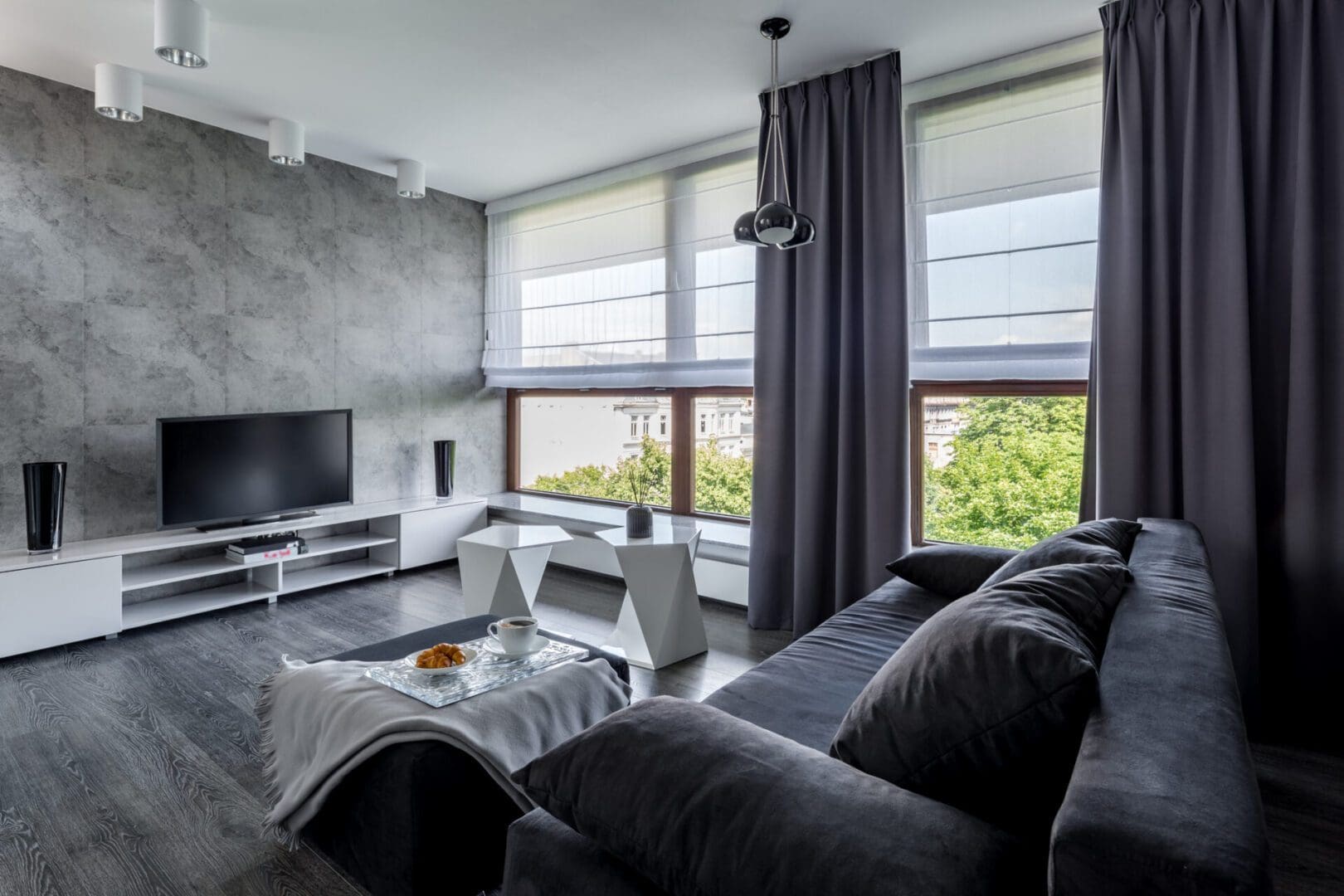 Modern gray living room with large windows