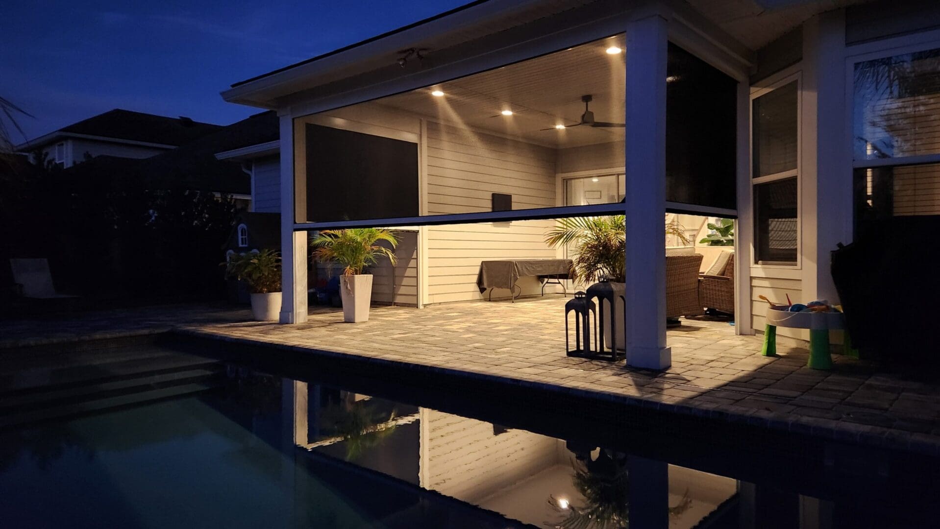 Evening-lit patio with pool reflection