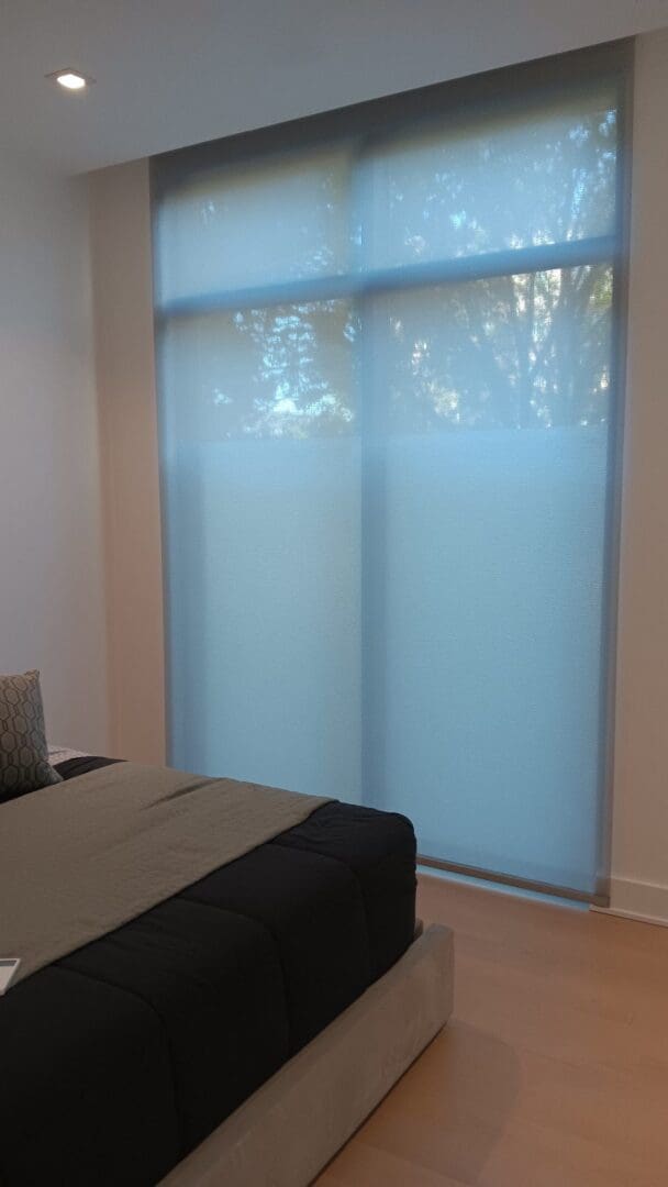 Modern bedroom with blue roller window shades