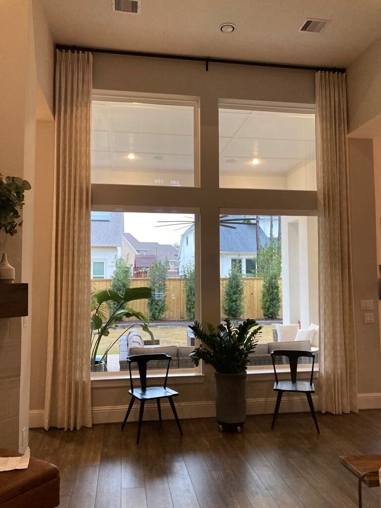 Living room window overlooking fenced backyard
