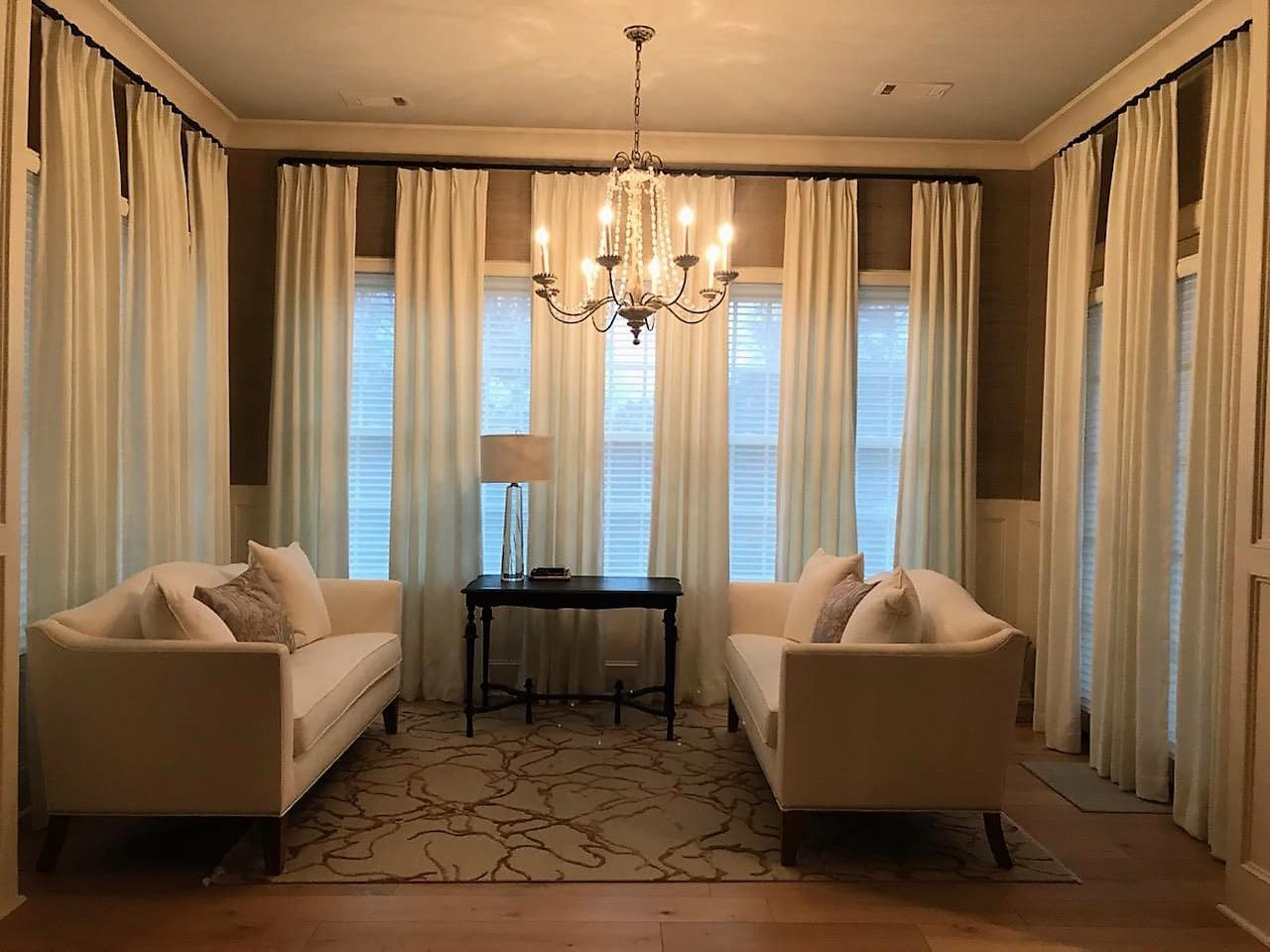 Symmetrical living room with chandelier and sofas