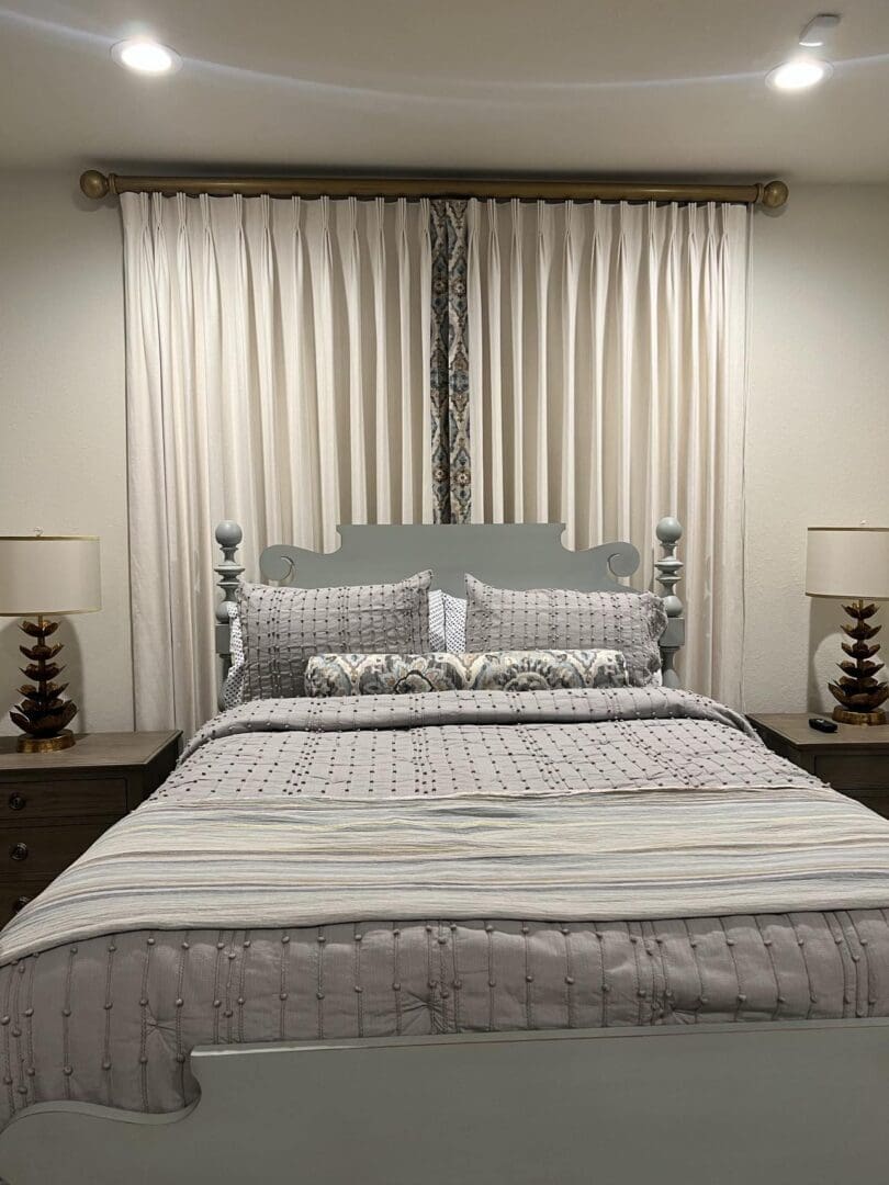 Neutral bedroom with layered bedding and lamps