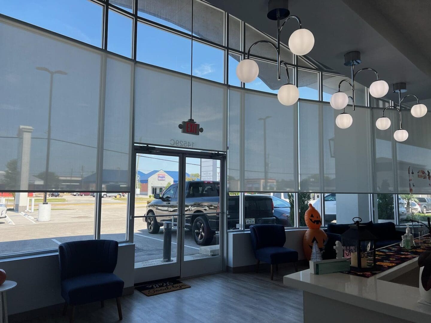 Car dealership showroom with Halloween pumpkin
