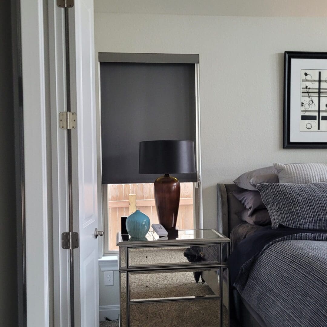 Mirrored bedside table with lamp and vase