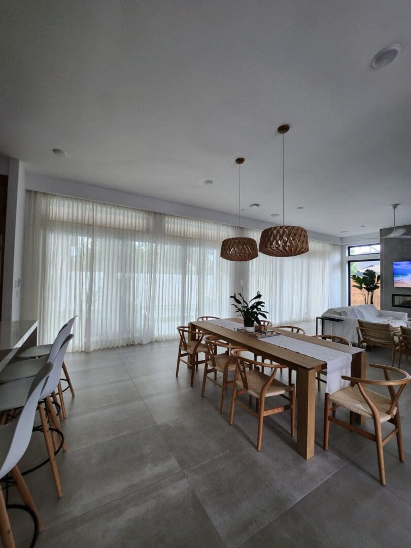 Modern dining room with wooden table and pendants